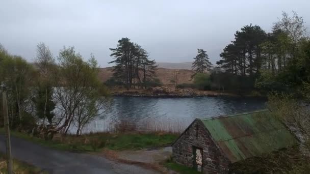 Flight over a typical Irish ruin to a beautiful lake — Stock Video