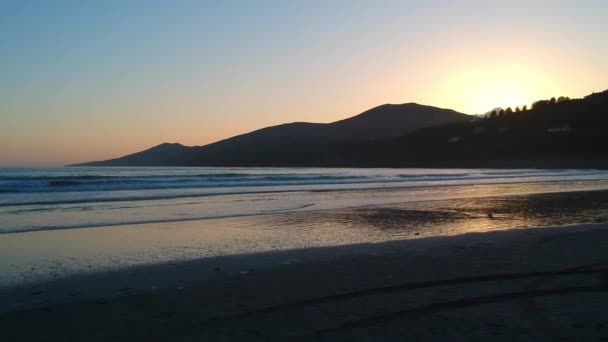 Vlucht over Inch strand Ierland bij zonsondergang — Stockvideo