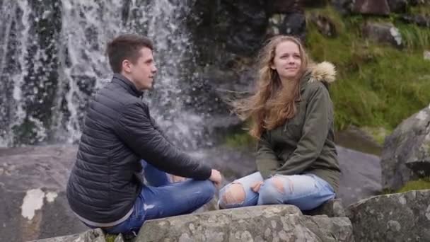 Dos amigos disfrutan del maravilloso paisaje en la cascada Torc en Irlanda — Vídeos de Stock