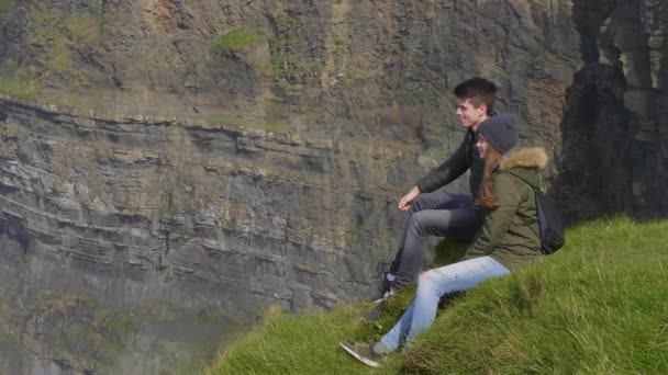 Ζευγάρι απολαμβάνει την θέα πάνω στους βράχους του Μόχερ στην Ιρλανδία — Αρχείο Βίντεο