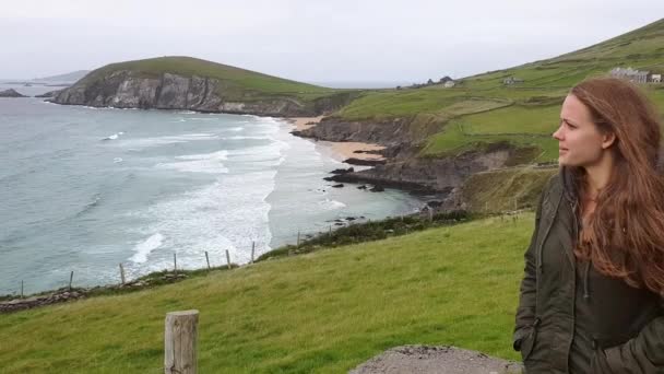 Όμορφο κορίτσι περπατά κατά μήκος της δυτικής ακτής της Ιρλανδίας στη χερσόνησο Dingle — Αρχείο Βίντεο