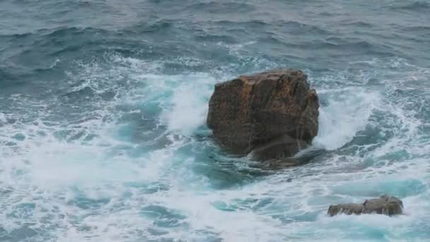 Olas salvajes y fuertes golpeando contra rocas en el océano — Vídeo de stock