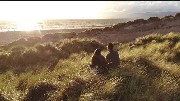 Jovem casal no Oceano Atlântico ao pôr do sol — Fotografia de Stock