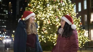 Bir Noel ağacı önünde iki kız New York'ta harika vakit