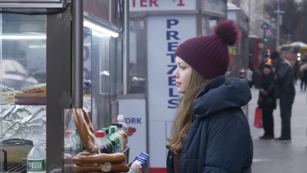 Junge Frau kauft einen Hot Dog in den Straßen von New York — Stockvideo