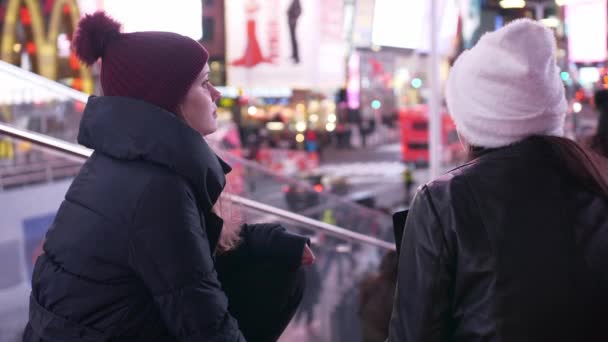 Dos chicas en Nueva York disfrutan de la increíble vista de Times Square por la noche — Vídeos de Stock