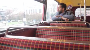 Adam eski bir Londra otobüs şehrin içinden seyahat ederken oturur