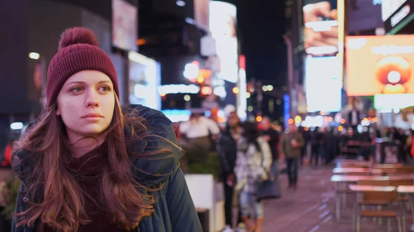 Walking on Times Square New York by night while doing a sightseeing trip to Manhattan