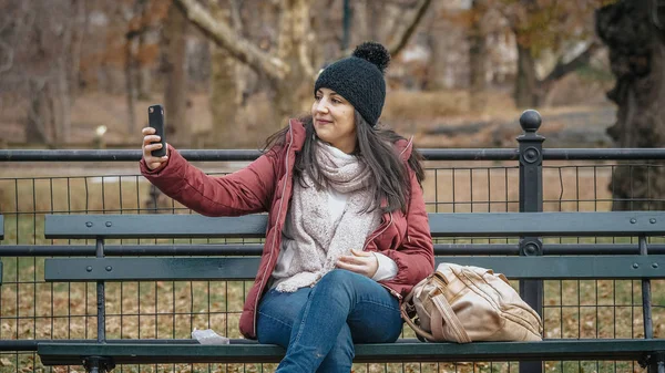 Taking a selfie while relaxing on a bench at Central Park — Stock Photo, Image