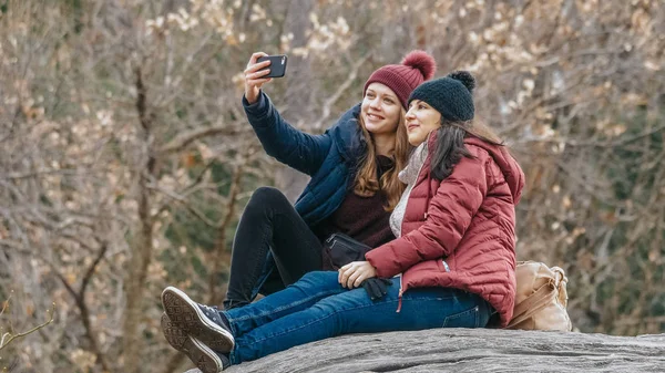 Dos chicas se sientan en una roca en Central Park Nueva York —  Fotos de Stock