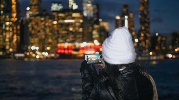 Young woman enjoys the fantastic view over the Manhattan skyline by night — Stock Photo, Image