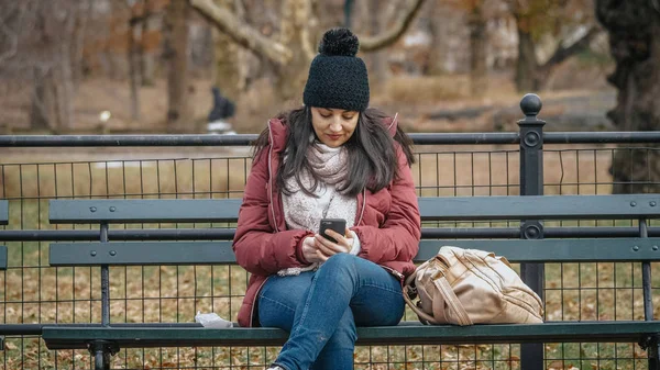 Fiatal nő ül egy padon a Central Park New York — Stock Fotó