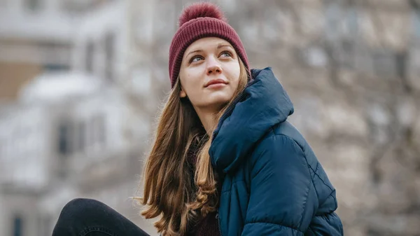 Young woman relaxes on a rock at Central Park New York