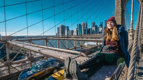 Young beautiful woman on Brooklyn Bridge New York enjoys a wonderful sunny day — Stock Photo, Image