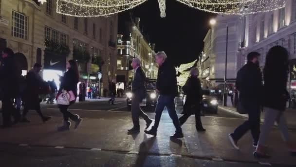 Pessoas atravessam a rua em Londres à noite - LONDRES, ENGLÂNDIA - 16 DE DEZEMBRO DE 2018 — Vídeo de Stock