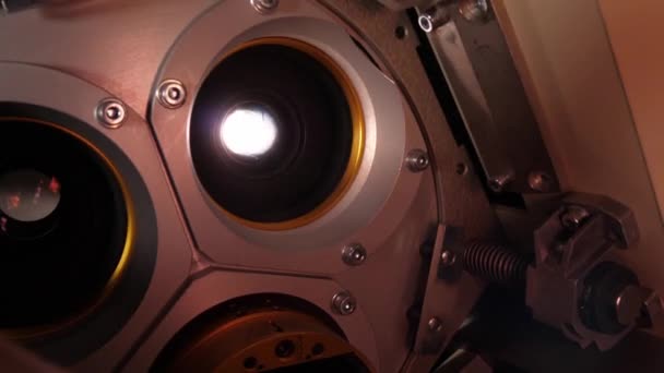 The lens of a cinema projector in a movie theater - close up view — Stock Video