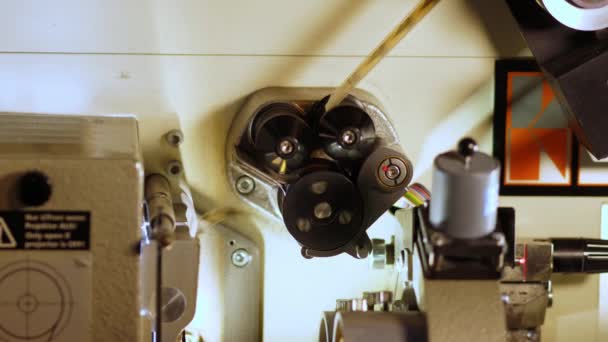 Film runs through a 35mm projector in a movie theater — Stock Video