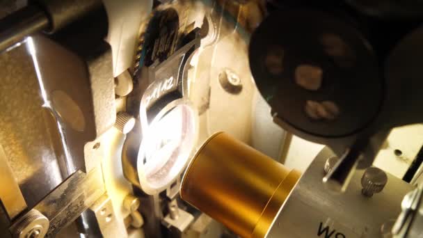 Vintage 35mm film running through a cinema projector in a movie theater — Stock Video
