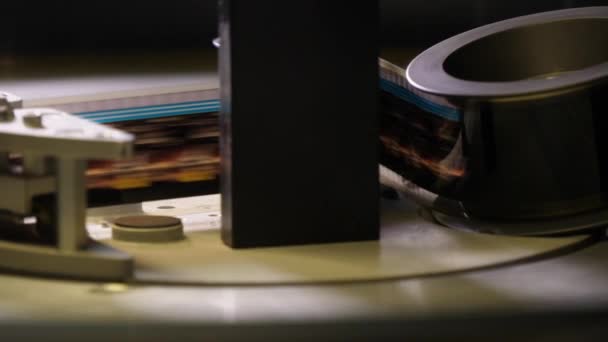 Film runs through a 35mm projector in a movie theater — Stock Video