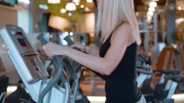 Genç ve seksi kız spor salonunda koşuyor.
