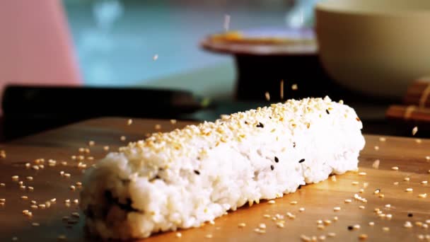 Сезам падает на суши-ролл - замедленная съемка — стоковое видео