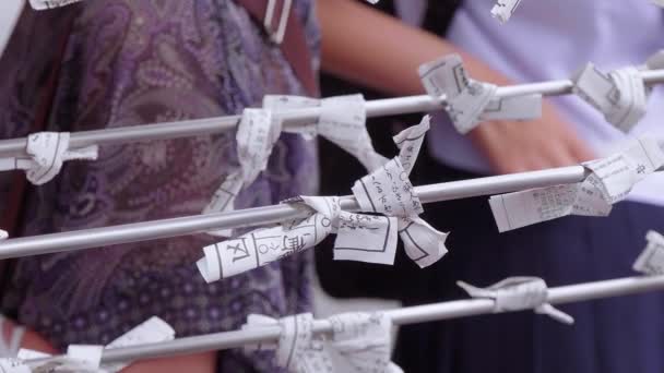 Omikuji - bad fortune papers at a Buddhist temple or Shinto Shrine — Stock Video