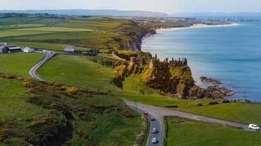 Aerial view over famous Dunluce Castle in North Ireland - travel photography clipart