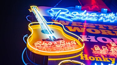 Colorful neon signs at Nashville Broadway - NASHVILLE, TENNESSEE - JUNE 15, 2019 clipart