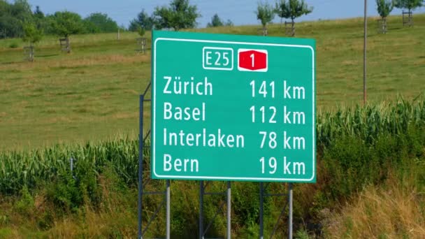 Direction signs to Zurich and Basel on the Swiss freeway - SWISS ALPS, SWITZERLAND - JULY 20, 2019 — ストック動画