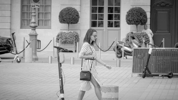 French girl walks over Vendome Square in Paris - CITY OF PARIS, FRANCE - JULY 29, 2019