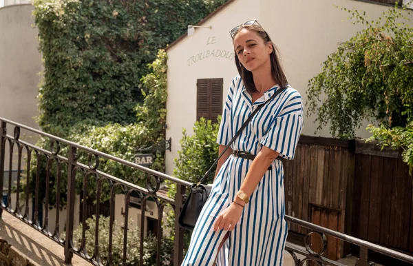 French woman relaxes on Montmartre Hill in Paris - CITY OF PARIS, FRANCE - JULY 29, 2019