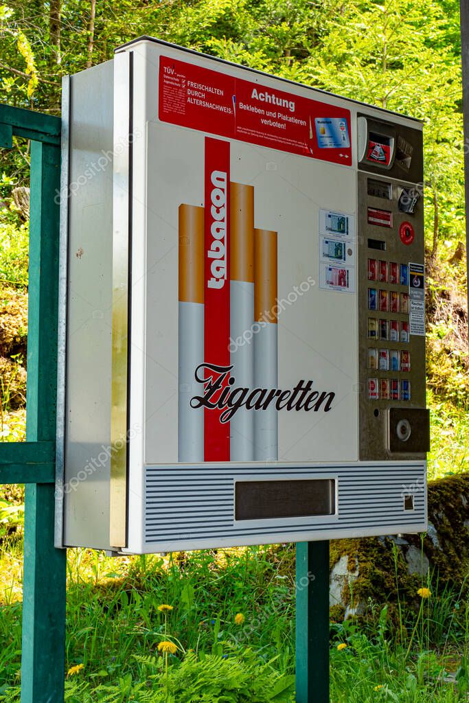 Cigarettes vending machine in a park - GRAINAU, GERMANY - MAY 26, 2020.