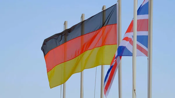 German and British flag waving in the wind — Stock Photo, Image