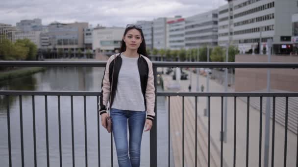 Young Asian woman poses for the camera in an urban area — Stock Video