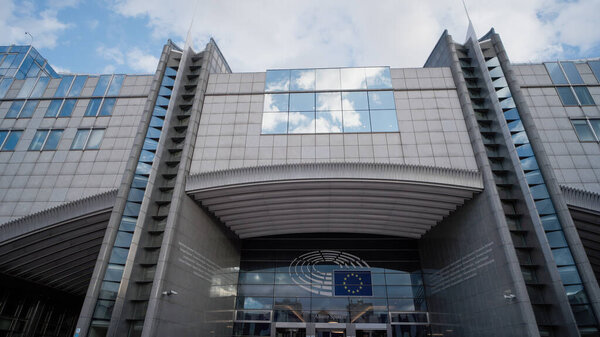 BRUSSELS, BELGIUM - SEPTEMBER 12, 2025 - European Parliament building facade showcasing modern architecture and the EU symbol