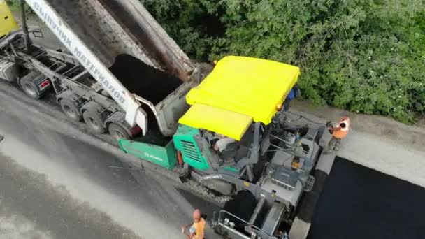 CHERKASSY REGION, UKRAINE - MAY 31, 2018: Aerial view on repair of a highway, the process of laying a new asphalt covering, Road construction works. — Stock Video