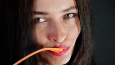 kırmızı seksi esmer kadın portresi kim eroticly dudakları ve şakacı şık gözlük, gözlük ve kamera Studio cinsel açıdan bakarak çalışır. koyu gri arka plan.