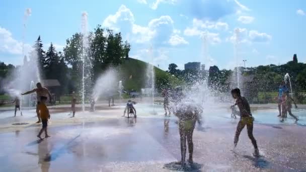 CHERKASY, UCRAINA 14 LUGLIO 2018: I bambini felici si divertono a giocare nella fontana d'acqua della città nella calda giornata estiva. Genitori con i loro figli. Tempo libero famiglia attiva, concetto di ecologia . — Video Stock