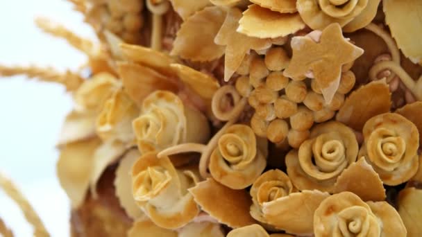 Close-up, wedding loaf, cake, bread, decorated with various colors of dough, roses, dough leaves. wedding traditions, decor — Stock Video