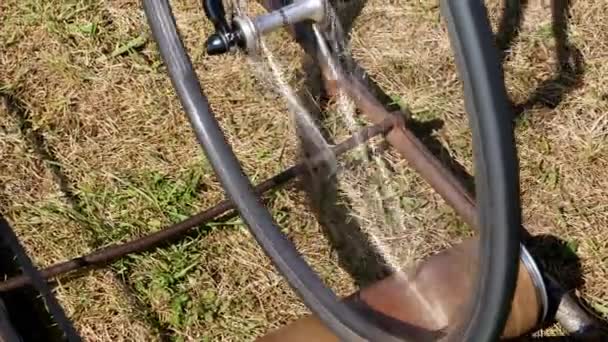 Close-up, as rodas de uma bicicleta de exercício velho, o passeio de bicicleta em um só lugar com a ajuda de um dispositivo elétrico auto-feito especial, instalação . — Vídeo de Stock