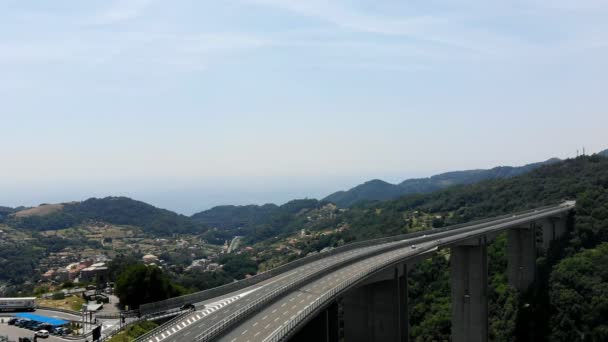 OVADA, ITÁLIA - JULHO 7, 2018: uma grande ponte, uma autobahn, rodovia elevando-se sobre um penhasco, conectando duas montanhas. Movimento activo na ponte. Nas terras altas da Itália , — Vídeo de Stock