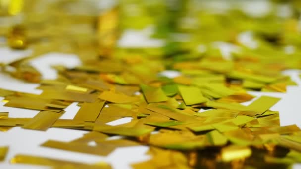 Close-up, golden spangles from crackers, festive tinsel, decorations. — Stock Video