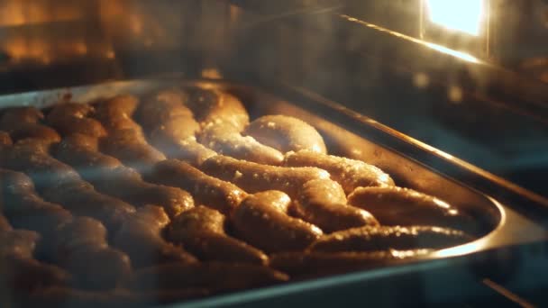 Detail, domácí klobása vaření proces velké průmyslové pece, v průmyslových kuchyní. Lahodný domácí pečené klobásy v troubě — Stock video