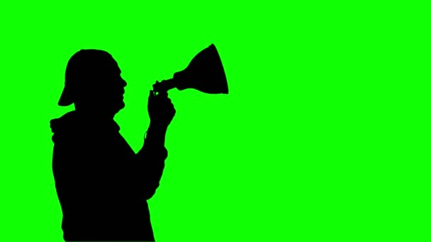 Black silhouette of protester holds a megaphone, shouts out slogans, on green background. Activist at a protest, rally, demonstration — Stock Video