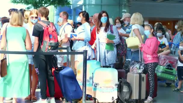 BORISPYL, UKRAINE, 31 Temmuz 2020: havaalanında, koruyucu maskeli, bavullu, kontrol gişelerinde sırada bekleyen insanlar. Coronavirüs salgınından sonra uçuşlar başlıyor.. — Stok video
