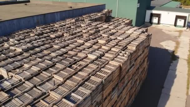 Warehouses. stacks of wooden crates for fruit, large boxes for apples stand outdoors, on warehouse territory. aero. top view. apple storage. apple harvest. — Stock Video