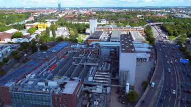 Güneşli bir günde trafiğin aktığı Berlin 'de sanayi bölgesinden geçen bir otoyolun hava görüntüsü. panorama genel görünüm dronu 