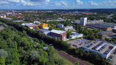 Berlin, Almanya 'daki Tempelhof Ufa Stüdyoları' nın hava görüntülerinde binalar, ağaçlar ve çevre kent manzaraları görülüyor. geniş yörünge görünümü dronu 