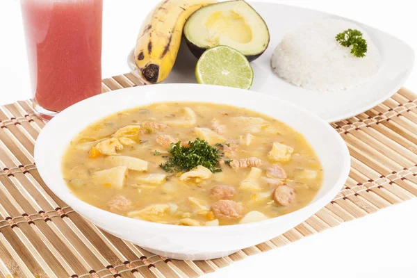 tasty typical Colombian food; Mondongo of soup with avocado, banana and white rice