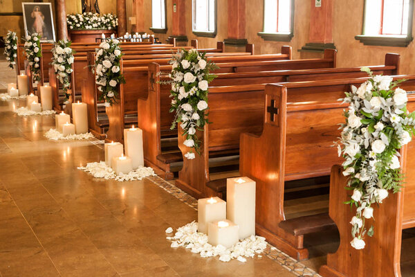 Medellin, Antioquia / Colombia; May 23, 2019: Catholic temple decorated with flowers and candles for wedding.